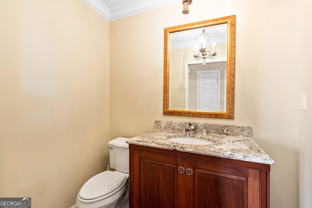 bathroom with crown molding, vanity, and toilet