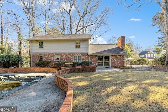 rear view of house with a patio area and a yard