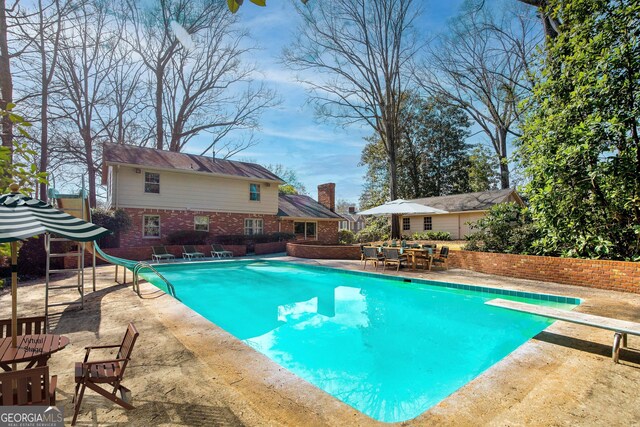 back of house featuring a lawn and a patio