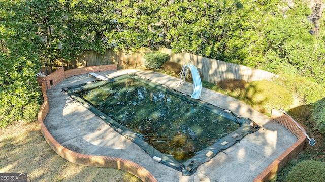 view of swimming pool featuring a water slide