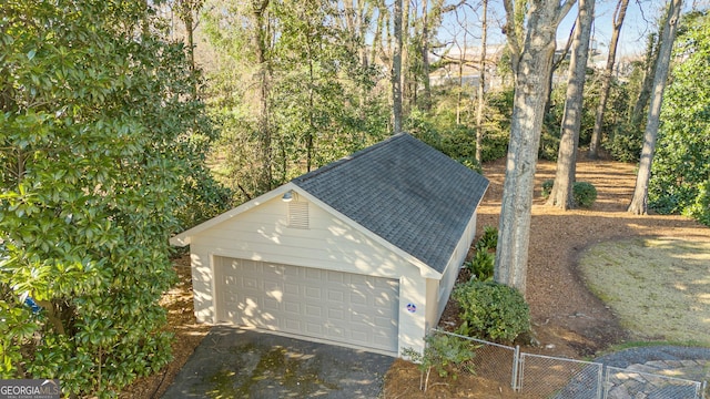 garage featuring a gate and fence