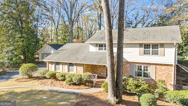 view of front of property with a porch, brick siding, and a shingled roof