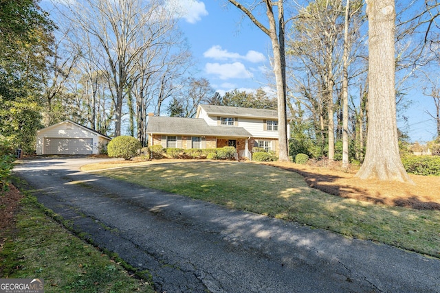 front facade with an outbuilding, a front lawn, and a garage