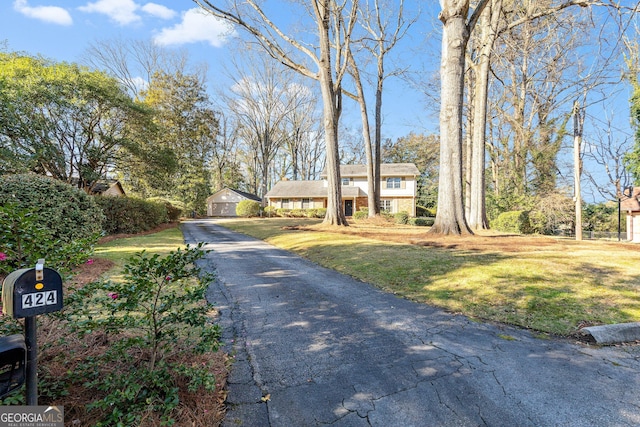 view of front of house featuring a front yard and a garage