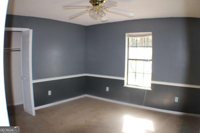 unfurnished bedroom with carpet flooring, ceiling fan, and a closet