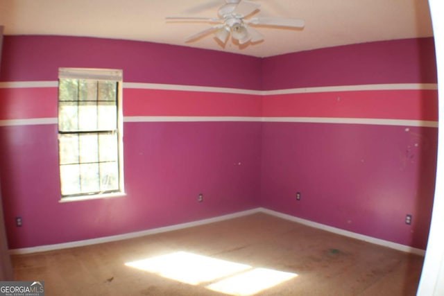 empty room featuring ceiling fan and carpet floors