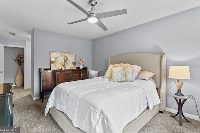 bedroom featuring light carpet and ceiling fan