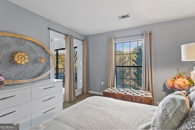 bedroom with dark colored carpet and access to outside