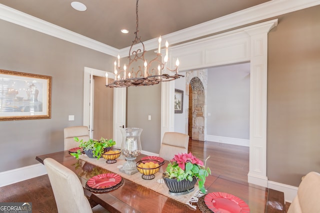 dining room featuring crown molding, dark hardwood / wood-style floors, and a notable chandelier