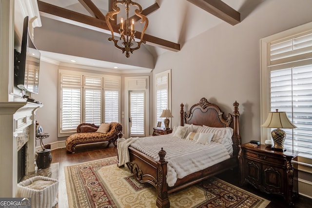 bedroom featuring vaulted ceiling with beams, a fireplace, a chandelier, and hardwood / wood-style flooring