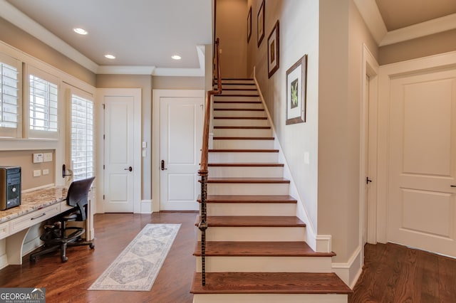 office space featuring ornamental molding, built in desk, and dark wood-type flooring