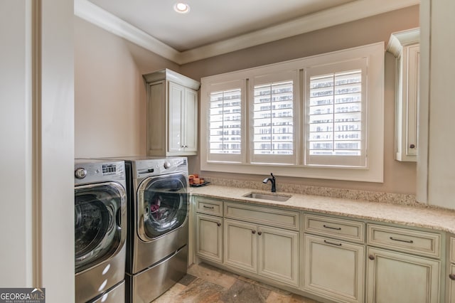 laundry area featuring crown molding, cabinets, separate washer and dryer, and sink