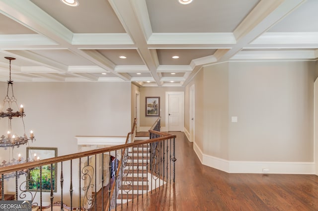 hall featuring beamed ceiling, coffered ceiling, and a chandelier