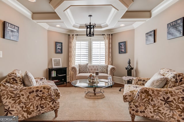 living room with hardwood / wood-style flooring, a notable chandelier, and crown molding