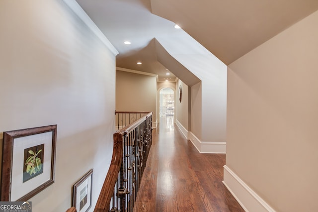 corridor with dark hardwood / wood-style flooring and crown molding