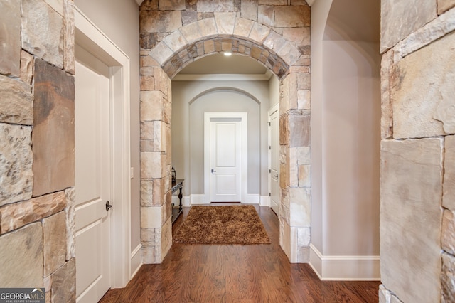 corridor featuring hardwood / wood-style flooring and ornamental molding