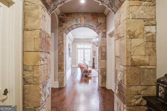 hallway with hardwood / wood-style floors, french doors, and ornamental molding