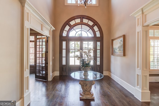 entryway with plenty of natural light, a high ceiling, and french doors