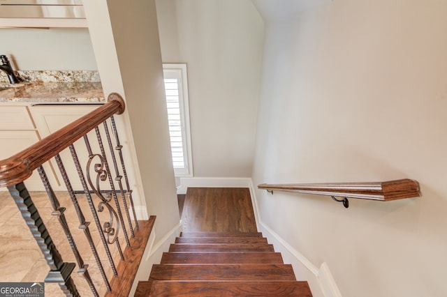 staircase with wood-type flooring