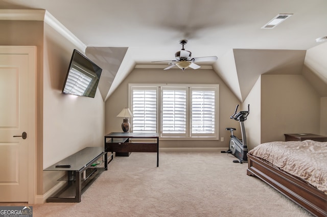 bedroom featuring ceiling fan, light colored carpet, vaulted ceiling, and ornamental molding