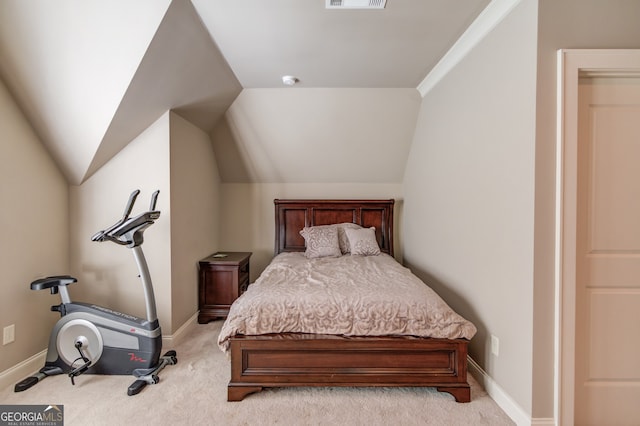 bedroom with light colored carpet, lofted ceiling, and crown molding