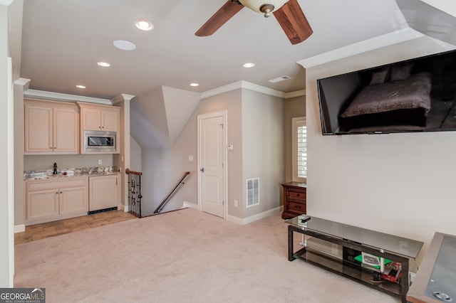 interior space with ceiling fan, ornamental molding, and sink