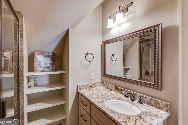 bathroom with vanity and a shower