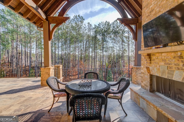 view of patio featuring an outdoor stone fireplace