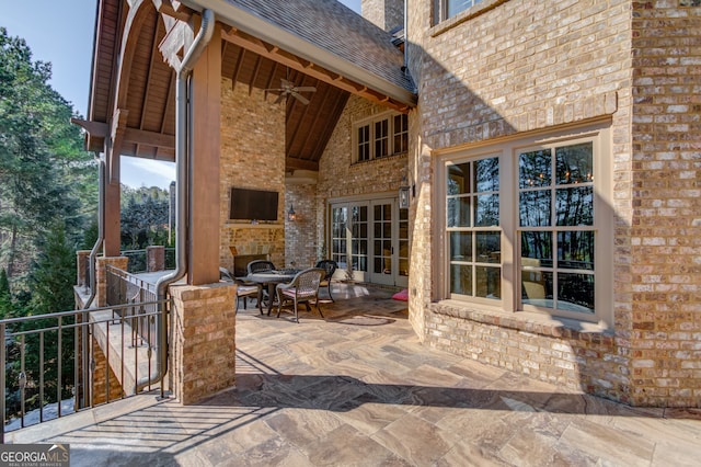 view of patio featuring ceiling fan and an outdoor stone fireplace