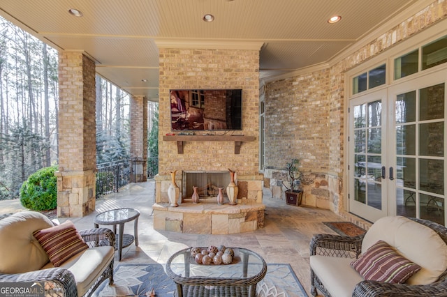 view of patio / terrace featuring an outdoor brick fireplace and french doors