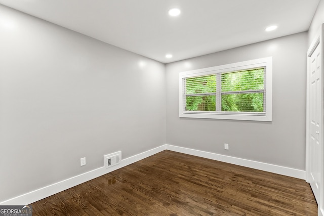 spare room featuring dark hardwood / wood-style floors