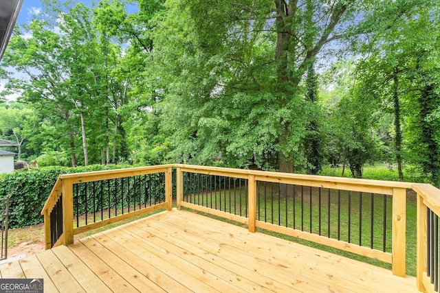 wooden deck featuring a yard