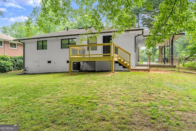 rear view of house featuring a wooden deck, central AC unit, and a lawn