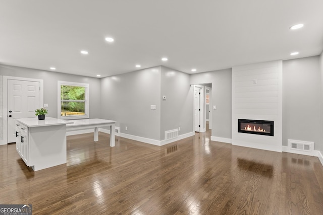 living room featuring dark hardwood / wood-style flooring and a fireplace