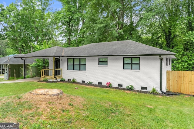 ranch-style house featuring a front yard and a carport