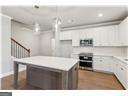 kitchen featuring decorative light fixtures and white cabinetry