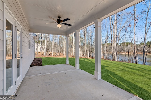 view of patio / terrace featuring a water view and ceiling fan