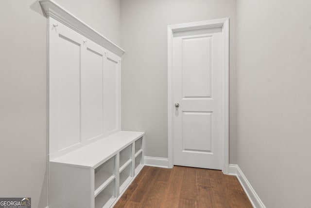 mudroom featuring dark wood-style flooring and baseboards