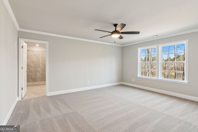 empty room with baseboards, visible vents, carpet flooring, and ornamental molding