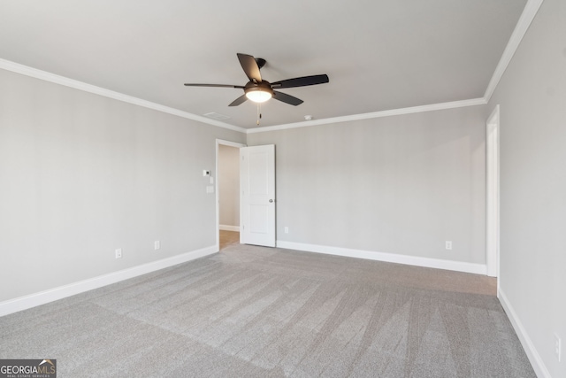 unfurnished room with baseboards, carpet flooring, and crown molding