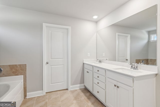 full bathroom with double vanity, a sink, a bath, and tile patterned floors