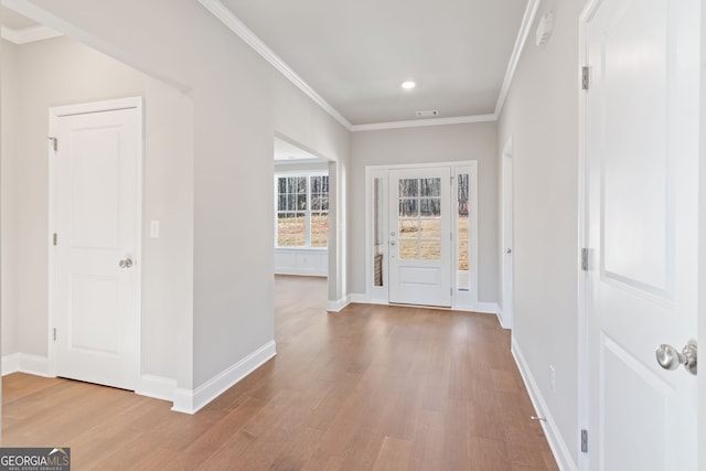 entrance foyer featuring crown molding, baseboards, and wood finished floors