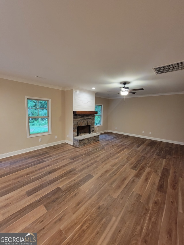 15 Dixon Rd, Newnan, GA 30263 - unfurnished living room featuring a healthy amount of sunlight, baseboards, ornamental molding, and visible vents