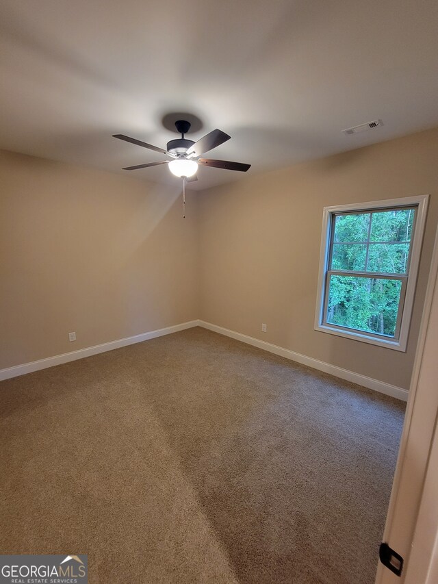 15 Dixon Rd, Newnan, GA 30263 - carpeted spare room featuring baseboards, ceiling fan, and visible vents