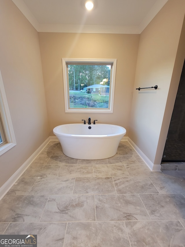 15 Dixon Rd, Newnan, GA 30263 - full bath with crown molding, baseboards, and a soaking tub