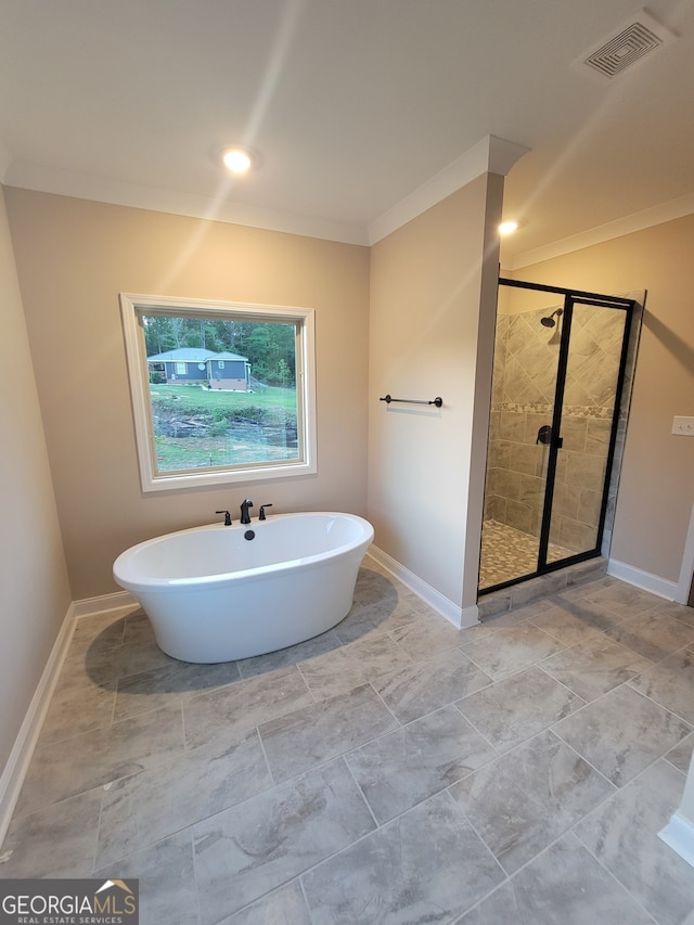 15 Dixon Rd, Newnan, GA 30263 - full bath with a soaking tub, baseboards, ornamental molding, and a shower stall
