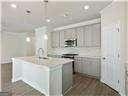 kitchen with a center island with sink and dark hardwood / wood-style flooring