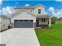 view of front of house featuring a garage and a front yard