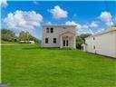 back of house featuring a lawn