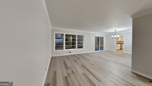 unfurnished living room featuring a chandelier, light wood-type flooring, and ornamental molding